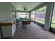 Screened patio with brick floors and seating area, perfect for outdoor relaxation at 179 Birchmont Dr, Deland, FL 32724