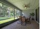 Screened patio with seating and table, perfect for outdoor relaxation at 179 Birchmont Dr, Deland, FL 32724