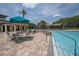 A luxurious community pool with ample seating options under umbrellas and covered areas, perfect for relaxation at 179 Birchmont Dr, Deland, FL 32724