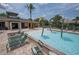 Relaxing community pool with lounge chairs, splash pad, and tropical water features next to the pool house at 179 Birchmont Dr, Deland, FL 32724