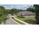 Street view of a charming home with lush landscaping, sidewalk, and a well-manicured lawn at 179 Birchmont Dr, Deland, FL 32724
