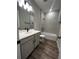 Bathroom features modern vanity and tiled shower/tub combo at 1881 Sunshine Peak Dr, Minneola, FL 34715