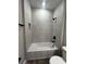 Bright bathroom with white tub and tiled walls at 1881 Sunshine Peak Dr, Minneola, FL 34715