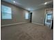A spacious bedroom with neutral carpet and ample natural light from two windows at 1881 Sunshine Peak Dr, Minneola, FL 34715