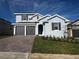 Charming two-story home with a brick driveway and well-maintained landscaping at 1881 Sunshine Peak Dr, Minneola, FL 34715