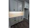 Contemporary kitchen cabinets with quartz countertops, sleek hardware, and mosaic backsplash at 1881 Sunshine Peak Dr, Minneola, FL 34715