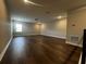 Large living area with dark wood floors and recessed lighting at 1881 Sunshine Peak Dr, Minneola, FL 34715