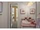 Bathroom with a granite countertop, bright lighting, and a doorway leading to an enclosed lanai at 2204 Baypoint Way, The Villages, FL 32162