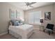 Neutral bedroom with a ceiling fan, plantation shutters, and stylish decor and furnishings at 2204 Baypoint Way, The Villages, FL 32162
