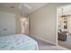 Bedroom with neutral carpet and a doorway leading to an enclosed lanai or outdoor space at 2204 Baypoint Way, The Villages, FL 32162