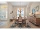 Bright dining room with an elegant chandelier, stylish furniture, and a neutral color palette at 2204 Baypoint Way, The Villages, FL 32162