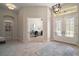 Spacious foyer features tile flooring, transom windows, and a view into the home office at 2204 Baypoint Way, The Villages, FL 32162