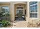 Beautiful entryway featuring double doors, decorative plants, windows, and a stone walkway at 2204 Baypoint Way, The Villages, FL 32162