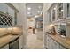 Bright hallway features tile flooring, granite countertops, white cabinetry and a view to the kitchen at 2204 Baypoint Way, The Villages, FL 32162