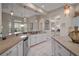 Modern kitchen with white cabinets, granite countertops, stainless steel appliances, and an open layout at 2204 Baypoint Way, The Villages, FL 32162
