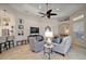 Inviting living room with tile floors, stylish furniture, a ceiling fan, and a neutral color palette at 2204 Baypoint Way, The Villages, FL 32162