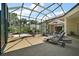 The screened patio features a jacuzzi, lounge chairs, and ample seating creating a seamless indoor-outdoor living space at 2204 Baypoint Way, The Villages, FL 32162