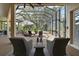 This screened patio features a jacuzzi, lounge chairs, outdoor seating, and seamless transition to the indoors at 2204 Baypoint Way, The Villages, FL 32162