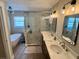 Bright bathroom featuring a double vanity, soaking tub, glass shower and modern lighting at 2227 S Spring Garden Ave, Deland, FL 32720