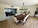Open-concept dining area with large table and view into the cozy living room at 2227 S Spring Garden Ave, Deland, FL 32720