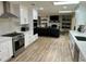Spacious kitchen leading to a cozy living room, featuring modern appliances and sleek countertops at 2227 S Spring Garden Ave, Deland, FL 32720