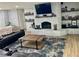 Cozy living room with a brick fireplace, built-in shelves, and comfortable leather seating at 2227 S Spring Garden Ave, Deland, FL 32720