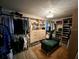 Spacious walk-in closet with built-in shelving and a comfortable green bench for relaxation at 2227 S Spring Garden Ave, Deland, FL 32720