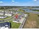 Aerial view of a modern townhome community near a lake and highway, indicated by a location pin at 2552 Chickasaw Plum Loop, Clermont, FL 34711