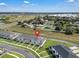 An aerial view of a townhome complex, showcasing well-manicured landscaping and a neighborhood layout at 2552 Chickasaw Plum Loop, Clermont, FL 34711