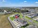 Aerial view showcases a community neighborhood with modern townhomes, well-maintained streets, and landscaped green spaces at 2552 Chickasaw Plum Loop, Clermont, FL 34711