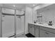 Bright bathroom featuring a glass-enclosed shower and double sink vanity at 2552 Chickasaw Plum Loop, Clermont, FL 34711
