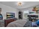 Cozy bedroom featuring a large dresser and a window view, complemented by collectibles at 2552 Chickasaw Plum Loop, Clermont, FL 34711