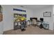 Spacious carpeted bedroom features a desk and gaming setup at 2552 Chickasaw Plum Loop, Clermont, FL 34711