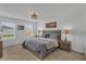 Main bedroom with a wooden bed frame, soft lighting, and a serene atmosphere at 2552 Chickasaw Plum Loop, Clermont, FL 34711