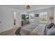Well lit main bedroom featuring a wooden bed frame, soft lighting, and a calm atmosphere at 2552 Chickasaw Plum Loop, Clermont, FL 34711