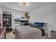 Comfortable bedroom with a well-lit desk area and decoratively displayed collectibles at 2552 Chickasaw Plum Loop, Clermont, FL 34711