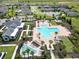 Aerial view of a community pool, splash pad, clubhouse and lush landscaping creating a relaxing and inviting atmosphere at 2552 Chickasaw Plum Loop, Clermont, FL 34711