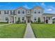 Inviting two-story townhome featuring a well-manicured lawn and a charming front entryway at 2552 Chickasaw Plum Loop, Clermont, FL 34711