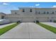 Modern townhome exteriors with individual driveways and attached garages in a well-maintained community at 2552 Chickasaw Plum Loop, Clermont, FL 34711