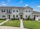 Attractive two-story townhouse with well-maintained landscaping at 2552 Chickasaw Plum Loop, Clermont, FL 34711
