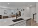 Kitchen with black modern faucet, view into living area at 2552 Chickasaw Plum Loop, Clermont, FL 34711
