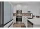 Stylish kitchen with stainless steel appliances, white cabinets, and a modern faucet at 2552 Chickasaw Plum Loop, Clermont, FL 34711