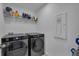 Laundry room featuring a modern Samsung washer and dryer and shelving for storage at 2552 Chickasaw Plum Loop, Clermont, FL 34711