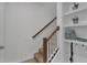Carpeted stairway with wood railing and white trim adjacent to built-in shelving at 2552 Chickasaw Plum Loop, Clermont, FL 34711