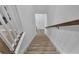Carpeted stairway with white risers and wood trim banister leading to an upper floor at 2552 Chickasaw Plum Loop, Clermont, FL 34711