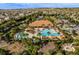 Aerial view of a community pool with palm trees and cabanas at 2602 Stargrass Cir, Clermont, FL 34715