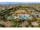 Expansive aerial view showcasing the resort-style pool, clubhouse, and lush greenery of the community at 2602 Stargrass Cir, Clermont, FL 34715