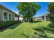 Spacious backyard with a manicured lawn and mature landscaping providing a private and serene outdoor space at 2602 Stargrass Cir, Clermont, FL 34715