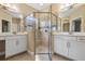 Modern bathroom boasts dual sinks, a walk-in glass shower, and neutral earth tones at 2602 Stargrass Cir, Clermont, FL 34715