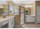 Spacious bathroom featuring dual vanity sinks, a walk-in shower, and stylish fixtures at 2602 Stargrass Cir, Clermont, FL 34715